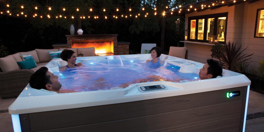 hot spring spas limelight collection page cspot lifestyle night group in spa 1 scaled