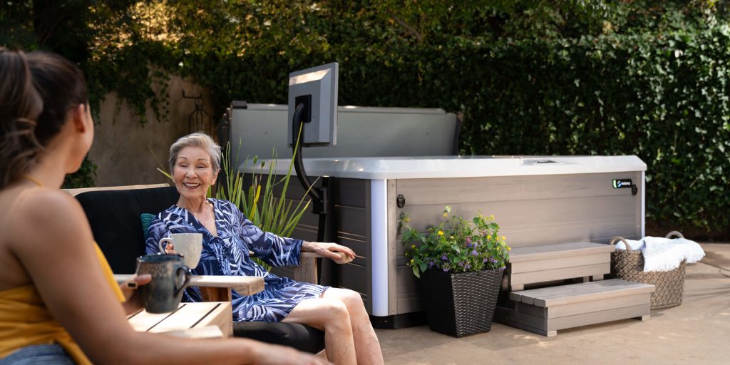 hot spring spas limelight collection page cspot lifestyle women sitting near spa 1 scaled